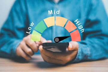 Businessman using smartphone with risk level indicator rating infographic since low to high for Risk management and assessment concept.