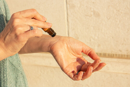 Essential oils roller bottle in the hand of a woman