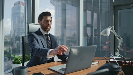 Business man finish laptop work shutting notebook lid. Boss getting up from desk