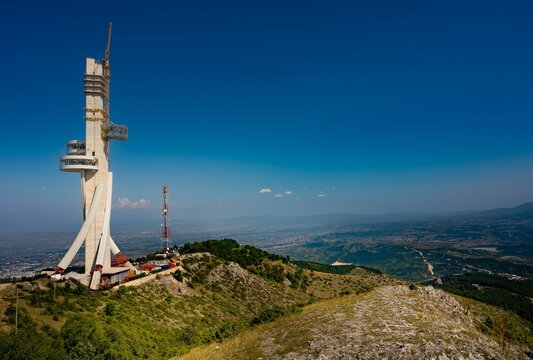 Communication tower on the Vodno evergreen hill against a blue sky in Skopje, Macedonia