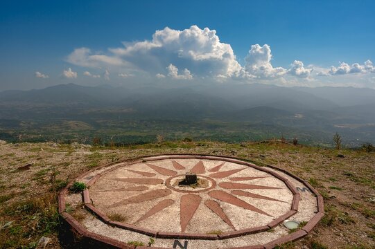 Compass on the viewpoint of Vodno hill with beautiful mountains in the background in Skopje