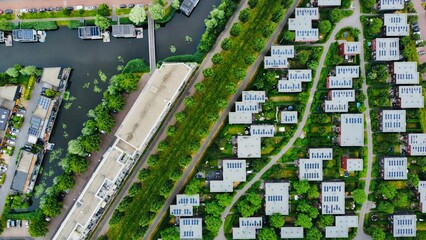 Bird's eye view of a lovely neighborhood with lush green trees surrounding flat-roofed buildings