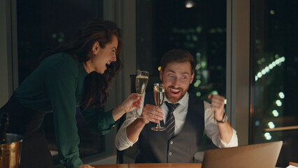 Couple coworkers drinking champagne celebrating business success at office.