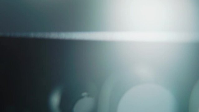 A macro shot of a black metal camera cage, video production equipment, on a 360 rotating stand, studio cinematic light, slow motion, 4K