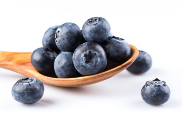 Fresh blueberries in wooden spoon
