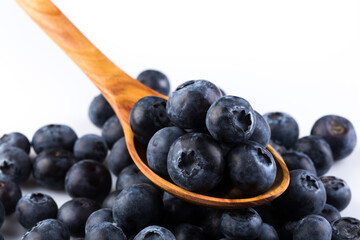Fresh blueberries in wooden spoon