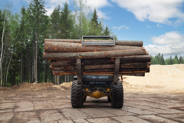Loading logs with a special loader.Timber products warehouse on a specialized site.