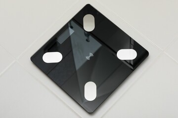 Closeup of a black bathroom scale on the white background