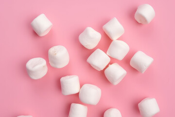 Fototapeta na wymiar Lots of sweet white puffy marshmallows isolated on a flat pink background, copy space for text. Wallpaper Top view of mouthwatering sugar marshmallow. Generative AI professional photo imitation.