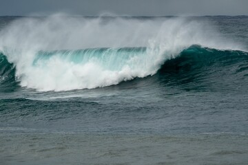 Closeup shot of big waves of the sea under a cloudy sky - great for wallpapers