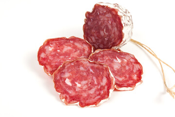 pile of red salami, on a white