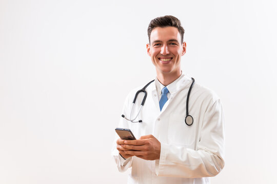 Image of young doctor using phone.