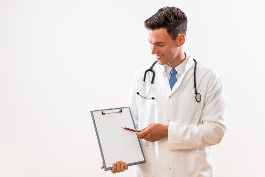 Image of young doctor  showing on clipboard.