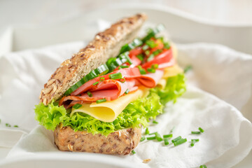 Delicious and homemade sandwich with ham, cheese and chive.