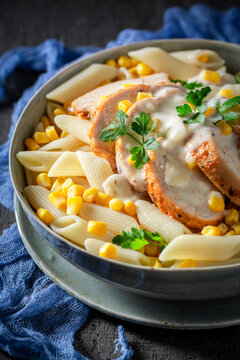 Homemade and tasty penne with bechamel sauce and corn.