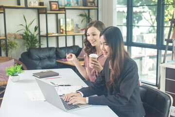 Two brunette business woman, talking, advising each other.