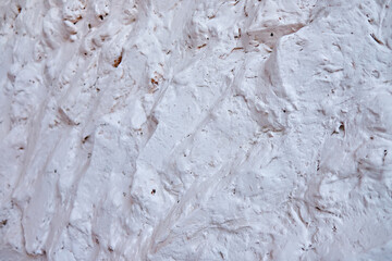 White plaster on the wall as a background texture. Close-up