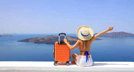 Happy moment with young woman tourist as orange the luggage in Santorini island,Greece