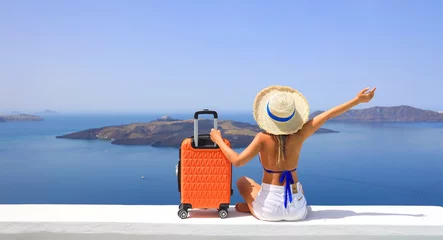 Poster Happy moment with young woman tourist as orange the luggage in Santorini island,Greece © SASITHORN