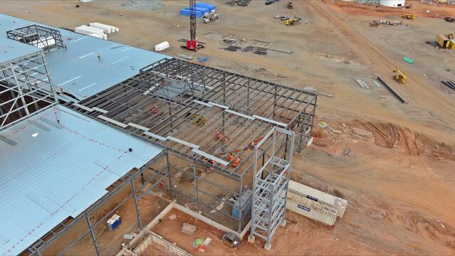 In order to work large cranes at construction site, a metal construction frame for construction of steel warehouse was installed