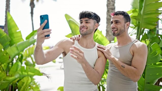 Two men couple smiling confident make selfie by smartphone at park