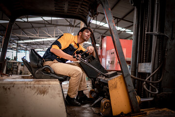 Fototapeta premium Worker industry factory wear safety uniform factory drive forklift truck moving goods to industry production shelves in factory warehouse area is industry transportation business concept.