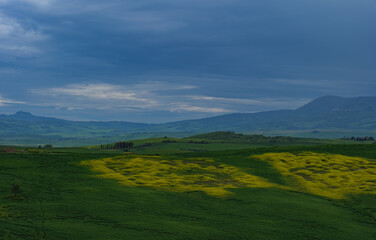 Tuscany fields in springtime, cloudy day mood, Val d'Orca, Pienza region