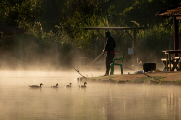 Man has fun fishing at park on Mai, 2023, Goiania, Brazil.