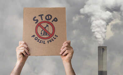 Stop fossil fuels poster on an smoking chimney background. CO2 emissions, battle for climate change