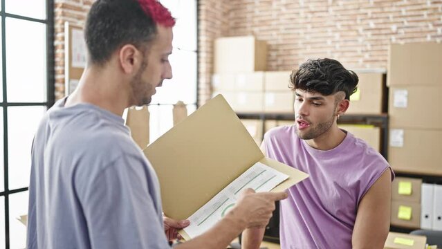 Two men ecommerce business workers reading document at office
