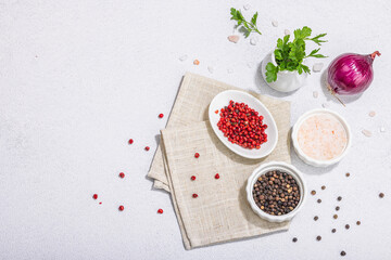Kitchen cooking background with assorted peppercorn, purple onion, fresh parsley and sea salt
