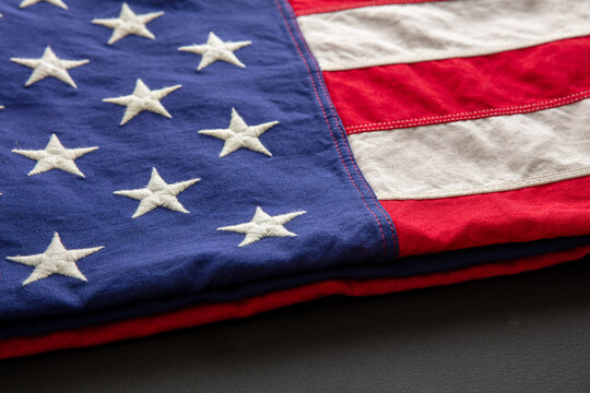 American flag folded on black abackground, US America National Holiday