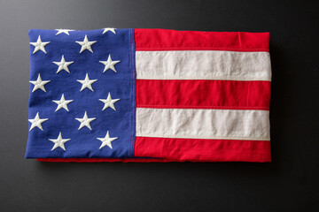 American flag folded on black abackground, US America National Holiday