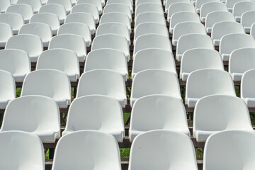 Naklejka premium Seats of tribune on sport stadium. Concept of fans, chairs for audience, cultural environment concept. mpty seats, modern stadium.