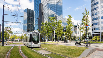 Tram in the city center, public transportation, modern buildings background