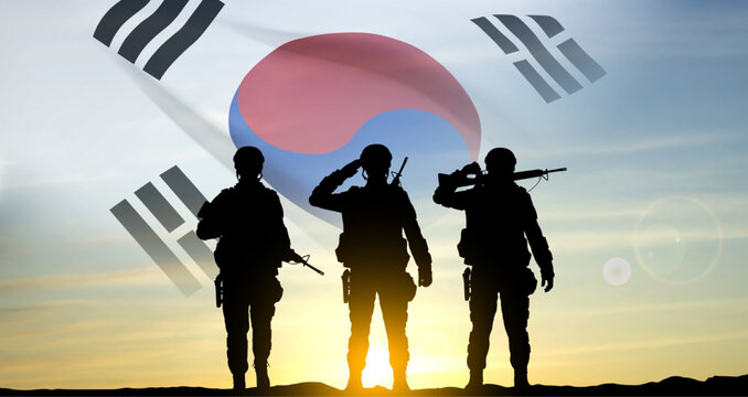 Silhouettes of a soldiers on background of sunset and flag of South Korea. Armed forces of South Korea concept. EPS10 vector