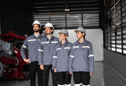 Confident robotic team, including women in non typically male-dominated field, crosses arms representing company's commitment to diversity and inclusion that accepts people all genders and cultures