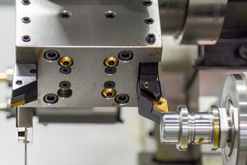 The  CNC lathe machine forming  cutting the metal shaft parts.