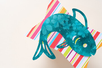 machine-cut paper fish on scrapbook paper shape close up