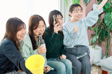 スポーツ観戦する女性4人