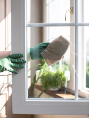 Washing windows. Home cleanliness care. Soap solution is splashed on the window. Clear glass....