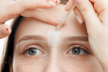 Brow correction, Master tweezers depilation of eyebrow hair in women