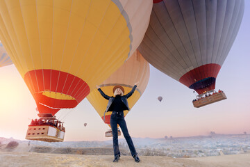 Traveler woman background landscape Cappadocia with hot air balloons sun light. Concept trip Turkey travel - obrazy, fototapety, plakaty
