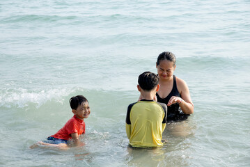 Obraz premium mother and son playing on the beach