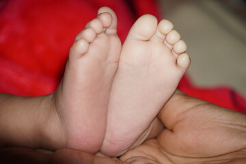 Obraz na płótnie Canvas Tiny Newborn Baby's feet close up. Happy child concept. Beautiful conceptual image of Maternity