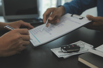 Man signing car insurance document or lease paper. Writing signature on contract or agreement....