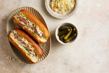 Gourmet grilled pork hots dogs with sauerkraut and pickles.Top view. Copy space.