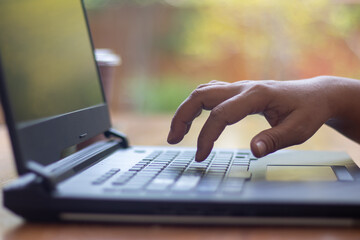hand typing keyboard working on laptop