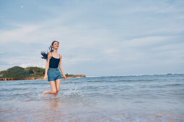 Fototapeta na wymiar woman summer running beauty travel young sea lifestyle sunset beach smile