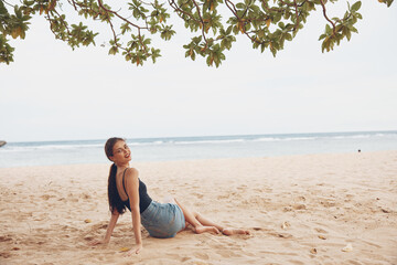 travel woman smile sitting beach nature sand freedom vacation sea person